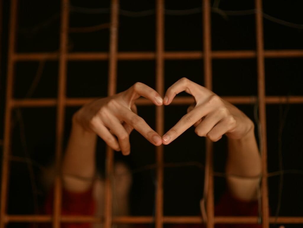 persons hand on brown metal frame