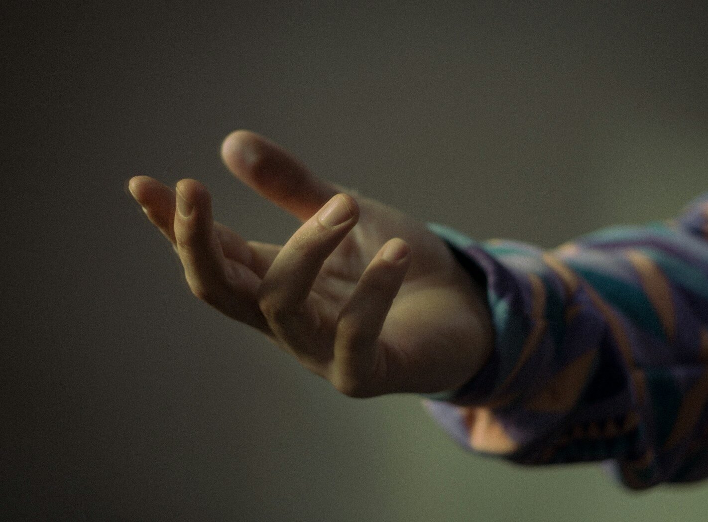 A hand reaching out with fingers spread