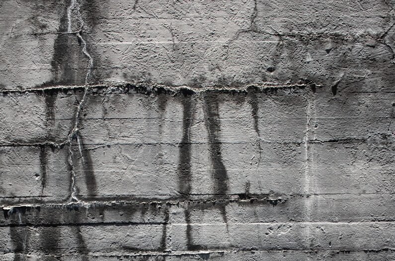 A black and white photo of graffiti on a wall