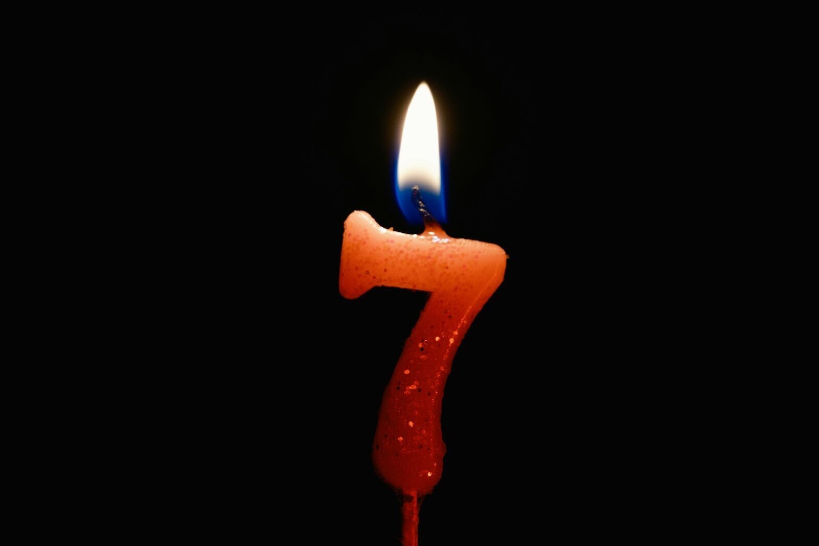 a red candle with a blue candle sticking out of it